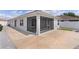 A screened in lanai is attached to the rear of the home, next to a fenced backyard at 7382 Se 167Th Zina Ln, The Villages, FL 32162