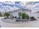 Landscaped front yard with decorative rock, palms, and various desert plants around the home at 7382 Se 167Th Zina Ln, The Villages, FL 32162
