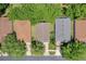 Aerial view of houses showing the roofs, driveways, and lush landscaping of the community at 791 Wolf Creek St, Clermont, FL 34711