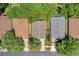 Aerial view of houses showing the property lines, roofs, driveways, and lush landscaping at 791 Wolf Creek St, Clermont, FL 34711