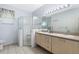 The bathroom has a double vanity with two sinks and a glass door walk-in shower at 791 Wolf Creek St, Clermont, FL 34711