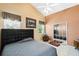 Comfortable bedroom featuring neutral colors, a ceiling fan, and a closet with mirrored doors at 791 Wolf Creek St, Clermont, FL 34711