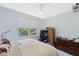 This bedroom includes a window with blinds, dresser, and wall-mounted TV at 791 Wolf Creek St, Clermont, FL 34711
