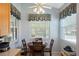 Charming breakfast nook with a round table, three chairs, and natural light streaming through the windows at 791 Wolf Creek St, Clermont, FL 34711