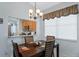 Cozy dining room featuring a wood table with four chairs, decorative window treatment, and ample natural light at 791 Wolf Creek St, Clermont, FL 34711