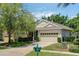 Charming single-story home boasts a brick driveway, attached garage, and lush landscaping in a serene neighborhood at 791 Wolf Creek St, Clermont, FL 34711