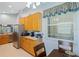 Bright kitchen with stainless steel appliances, natural wood cabinets, and breakfast nook area with natural light at 791 Wolf Creek St, Clermont, FL 34711