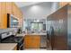 Well-equipped kitchen featuring stainless steel appliances, ample cabinet space, and a convenient breakfast bar overlooking the living areas at 791 Wolf Creek St, Clermont, FL 34711