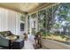 Bright sunroom features large windows with views of the green backyard and a pet friendly cat tree at 791 Wolf Creek St, Clermont, FL 34711