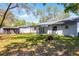Spacious backyard with a shed, a covered patio, and a charming fire pit at 8158 Bucksaw Dr, Orlando, FL 32817