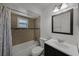 Bathroom with shower-tub, modern vanity, and tile walls at 8158 Bucksaw Dr, Orlando, FL 32817