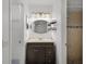 Bathroom with a single vanity, neutral walls, decorative mirror, and a tiled walk-in shower at 8158 Bucksaw Dr, Orlando, FL 32817