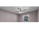 Neutral bedroom featuring a modern ceiling fan, a window, and neutral colored walls at 8158 Bucksaw Dr, Orlando, FL 32817