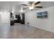 Open-concept living room offering tile floors, modern ceiling fan, and a view to the kitchen at 8158 Bucksaw Dr, Orlando, FL 32817