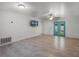 Living room showcasing tile floors, modern ceiling fan, and double doors to the backyard at 8158 Bucksaw Dr, Orlando, FL 32817
