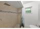 Tiled stand-up shower with rock floor and tiled walls at 8158 Bucksaw Dr, Orlando, FL 32817