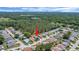 Aerial view of a neighborhood with mature trees, ponds, and well-maintained houses at 830 Grand Vista Trl, Leesburg, FL 34748
