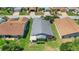 Aerial view of the property, highlighting the manicured lawn and screened patio at 830 Grand Vista Trl, Leesburg, FL 34748