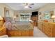 Charming bedroom features light-colored walls, comfortable bed, ceiling fan, and an exterior view at 830 Grand Vista Trl, Leesburg, FL 34748