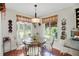 Cozy dining area with views of the backyard and patio, perfect for casual meals at 830 Grand Vista Trl, Leesburg, FL 34748