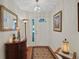 Inviting foyer with elegant decor, wood floors, and a decorative rug at 830 Grand Vista Trl, Leesburg, FL 34748