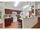 Open kitchen features granite countertops, ample cabinet space, and modern appliances at 830 Grand Vista Trl, Leesburg, FL 34748