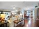 Bright and open living space with hardwood floors flowing into the adjacent dining area at 830 Grand Vista Trl, Leesburg, FL 34748