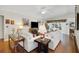Spacious living room with hardwood floors, bright couches, and lots of natural light at 830 Grand Vista Trl, Leesburg, FL 34748