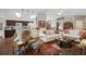 Bright and open living room with hardwood floors, comfortable seating, and adjacent kitchen view at 830 Grand Vista Trl, Leesburg, FL 34748