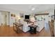 Spacious living room with hardwood floors, bright couches, and lots of natural light at 830 Grand Vista Trl, Leesburg, FL 34748