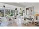 Cozy sunroom with white wicker furniture, tiled floors, and natural light at 830 Grand Vista Trl, Leesburg, FL 34748