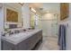 Modern bathroom with double vanity, marble countertops, and glass-enclosed shower at 910 Locust St, New Smyrna Beach, FL 32169