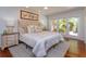 Cozy bedroom with comfortable bed, bedside tables, and bright natural light at 910 Locust St, New Smyrna Beach, FL 32169