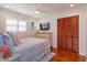 Comfortable bedroom with hardwood floors, decorative dresser, and a window with natural light at 910 Locust St, New Smyrna Beach, FL 32169