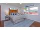 Cozy bedroom with nautical decor, wooden headboard, and a sun-filled windows at 910 Locust St, New Smyrna Beach, FL 32169