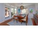 Bright dining room with modern table set and view of outdoor patio area at 910 Locust St, New Smyrna Beach, FL 32169