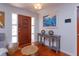 Inviting foyer showcasing a wood door, console table with decorative accents, and hardwood floors at 910 Locust St, New Smyrna Beach, FL 32169