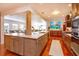 Spacious kitchen featuring wood cabinets, stainless steel appliances, and an island with stone countertops at 910 Locust St, New Smyrna Beach, FL 32169