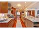 Modern kitchen with stainless steel appliances, wood cabinets, and a large island with marble countertops at 910 Locust St, New Smyrna Beach, FL 32169