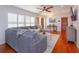 Comfortable living room showcasing a sectional sofa, hardwood floors, and natural light from the window at 910 Locust St, New Smyrna Beach, FL 32169