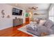 Comfortable living room with hardwood floors, a plush sofa, and stylish decor, creating a welcoming atmosphere at 910 Locust St, New Smyrna Beach, FL 32169