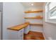 Bright office space with natural wood desk and shelving at 910 Locust St, New Smyrna Beach, FL 32169
