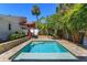 Private backyard pool surrounded by mature landscaping and a charming covered patio at 910 Locust St, New Smyrna Beach, FL 32169