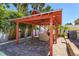 Outdoor cabana with a fireplace, grill and lounge seating by the pool at 910 Locust St, New Smyrna Beach, FL 32169