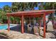 Relaxing poolside cabana with comfortable seating, fireplace and lush landscaping views at 910 Locust St, New Smyrna Beach, FL 32169