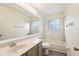 A well-lit bathroom with a large mirror, combination tub/shower, and a sink with vanity at 981 Piedmont Oaks Dr, Apopka, FL 32703