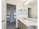 Bright bathroom features a modern vanity and a large mirror, open to the upstairs hallway at 981 Piedmont Oaks Dr, Apopka, FL 32703