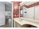 Bathroom with floral wallpaper, a single vanity, and a door that leads to the outdoors at 981 Piedmont Oaks Dr, Apopka, FL 32703