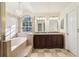 Elegant bathroom features a large tub, chandelier, and double vanity at 981 Piedmont Oaks Dr, Apopka, FL 32703