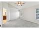 A bright bedroom featuring a ceiling fan and neutral decor and carpet at 981 Piedmont Oaks Dr, Apopka, FL 32703